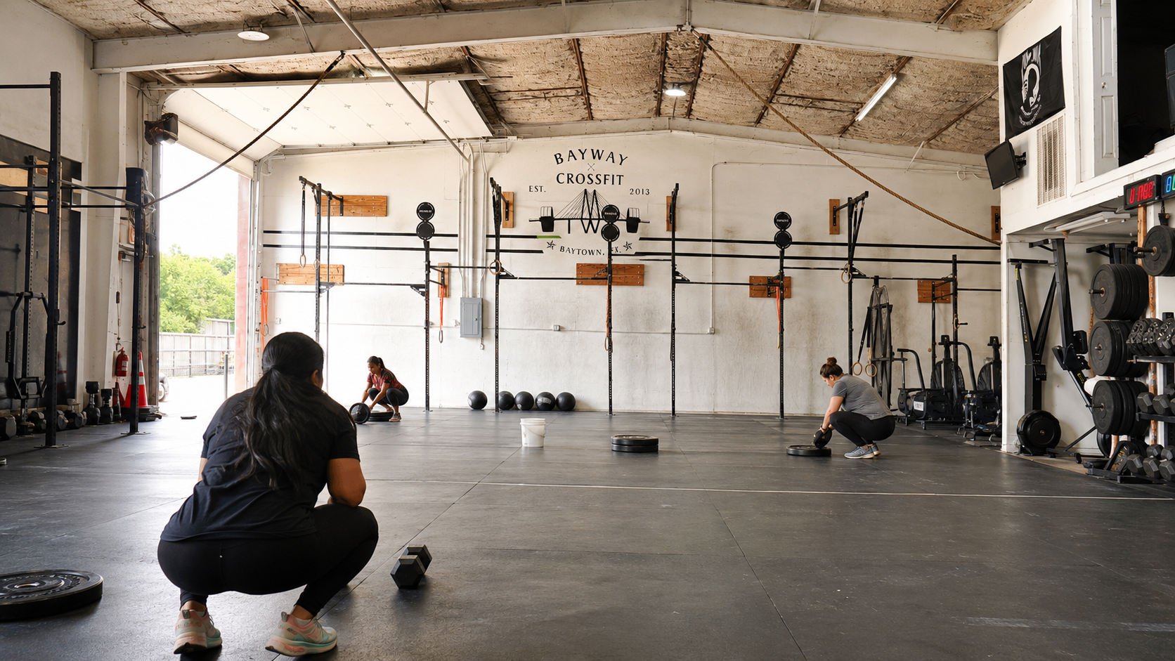 Women building grip strength during a CrossFit workout at BayWay CrossFit in Baytown Texas