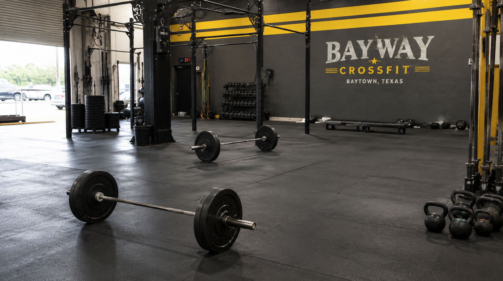 BayWay CrossFit gym in Baytown Texas with barbells, kettlebells, and workout equipment on the gym floor